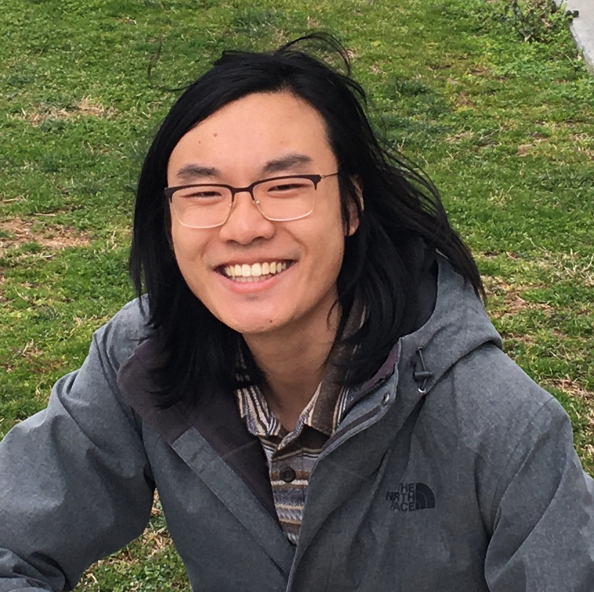 profile picture of Joshua Zhanson smiling in a winter jacket in front of a grassy background